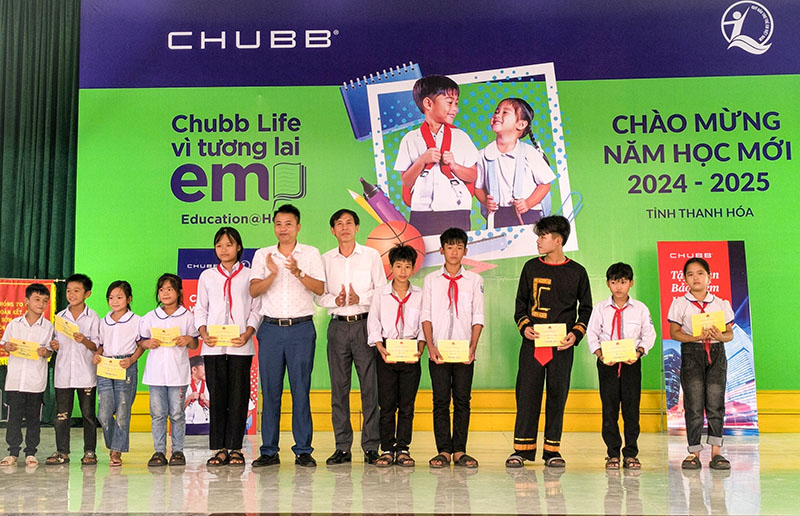 Đại diện lãnh đạo Quỹ BTTE và UBND huyện Nga Sơn trao học bổng cho trẻ em.