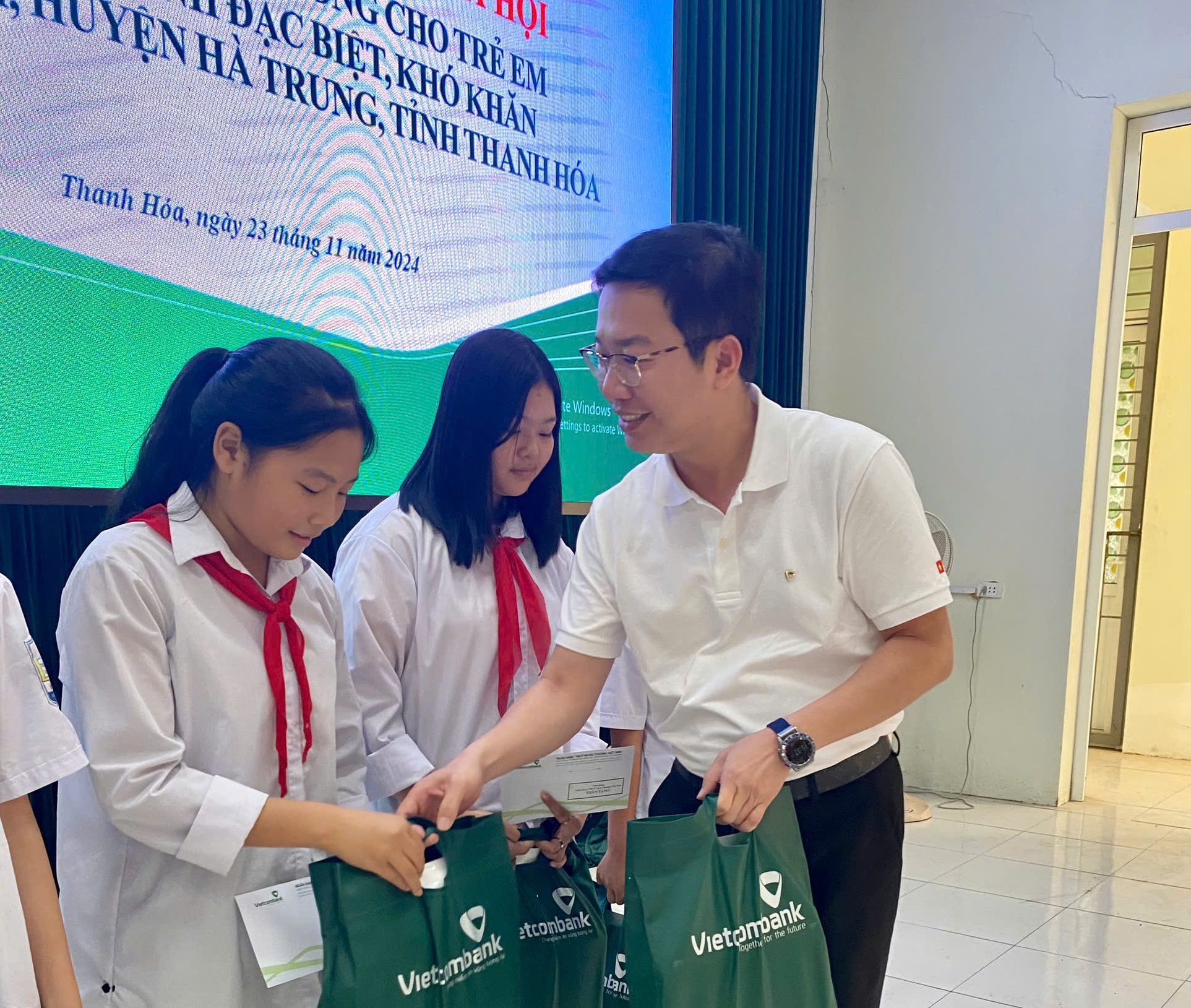Ông: Nguyễn Tiến Đạt, Chánh Văn phòng Trụ sở chính - Vietcombank Việt Nam trao quà cho trẻ em.